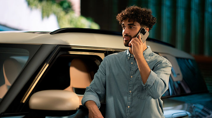 Vediamo un ragazzo appoggiato alla sua MINI intento a conversare al telefono.